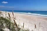 These pristine sand dunes near the launch pads at KSC are gently washed by the calm blue Atlantic Ocean. Sea oats stand like sentinels on the dunes, which are part of the Canaveral National Seashore, managed by the National Wildlife Service.